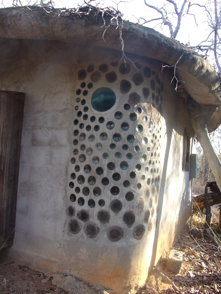 Hobbit type building with glass bottle wall
