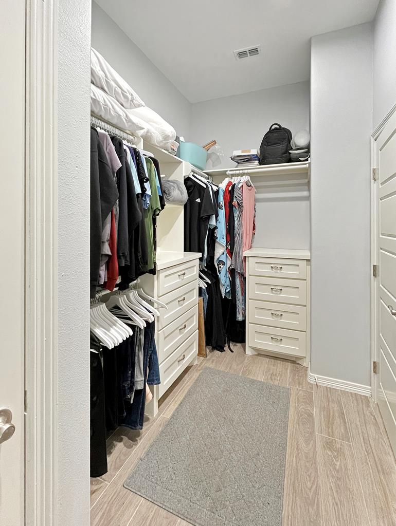 Primary bedroom walk-in closet