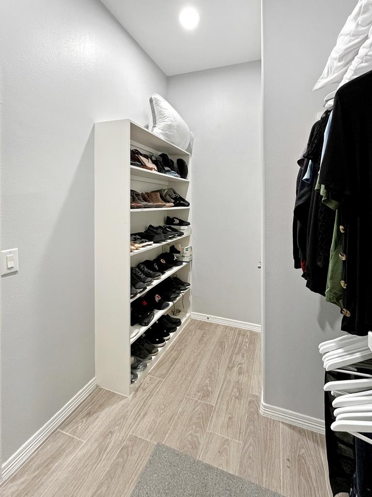 Primary bedroom walk-in closet