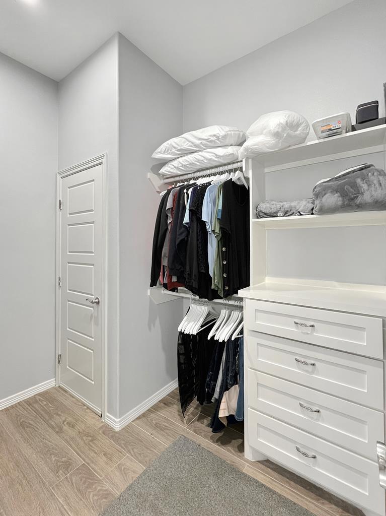 Primary bedroom walk-in closet