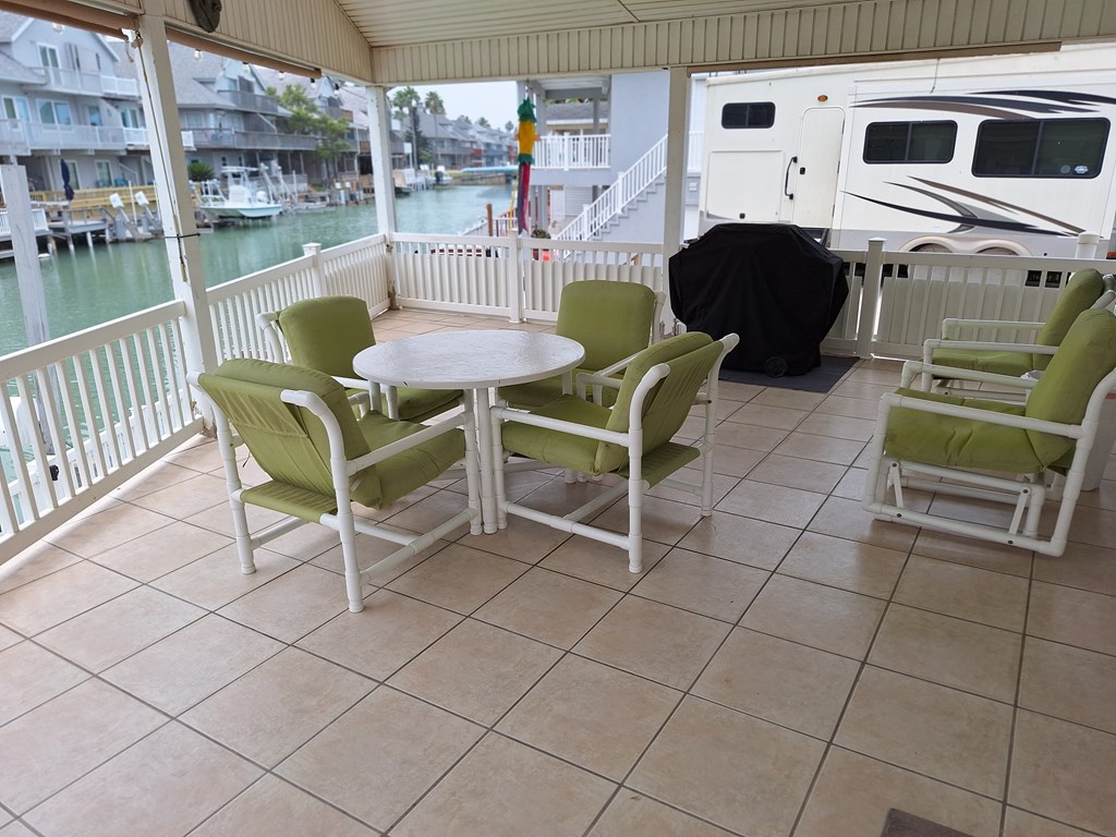 Spacious covered, tiled patio on the water