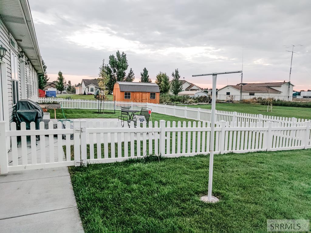 BACK YARD WITH FENCED IN PORTION 10X20 SHED