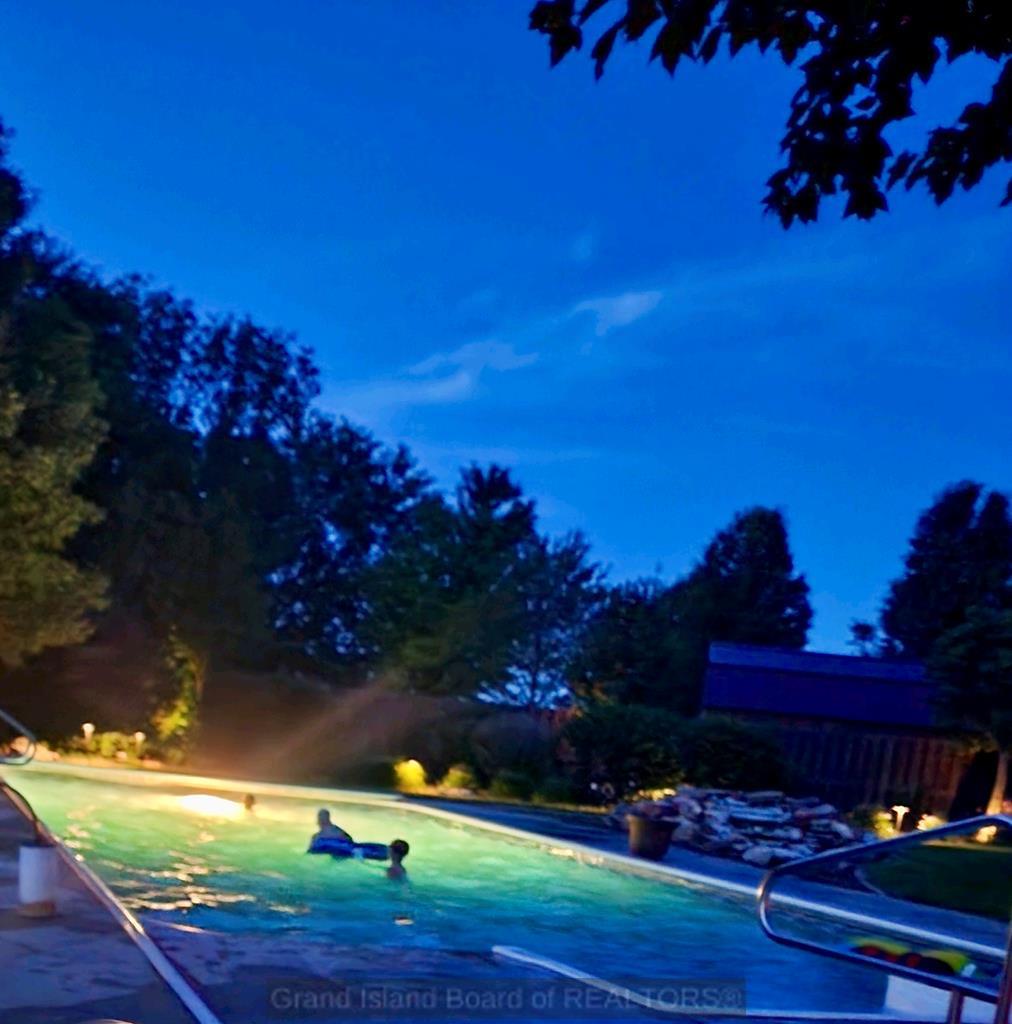 Pool with landscaping lights at night